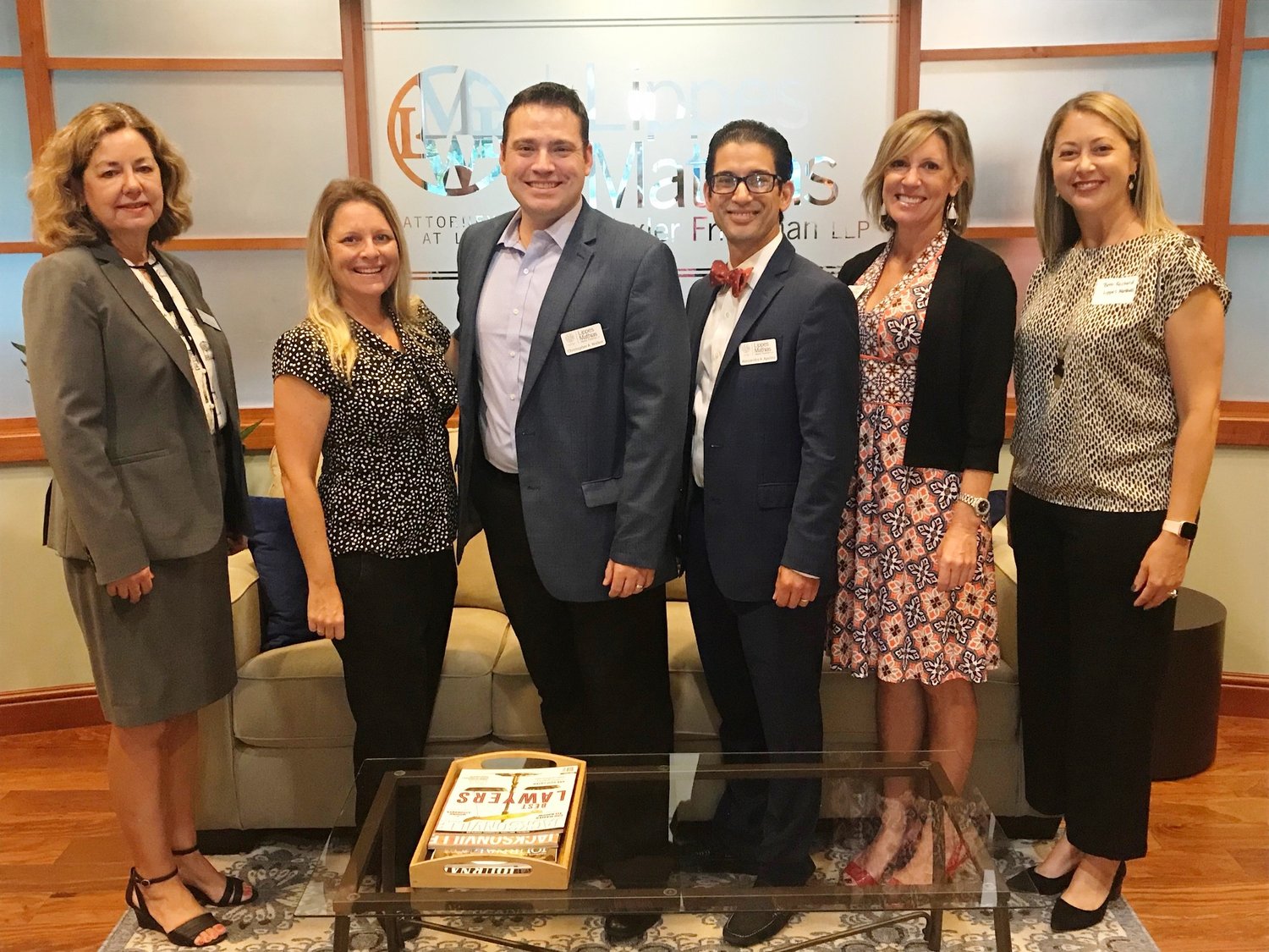 ) Karen Bourque Everett, Erika Hamer, Christopher Walker, Alessandro Apolito, Shannon M. Peabody and Bethany Reichard pose for a photo at the Chamber Before Hours event at Lippes Matthias Wexler Friedman LLP.
